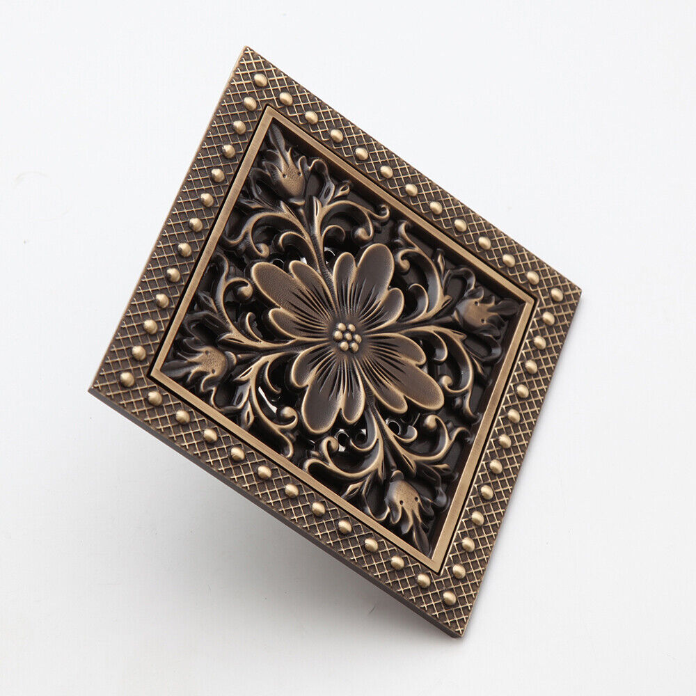 Bronze-colored shower drain with flower motif