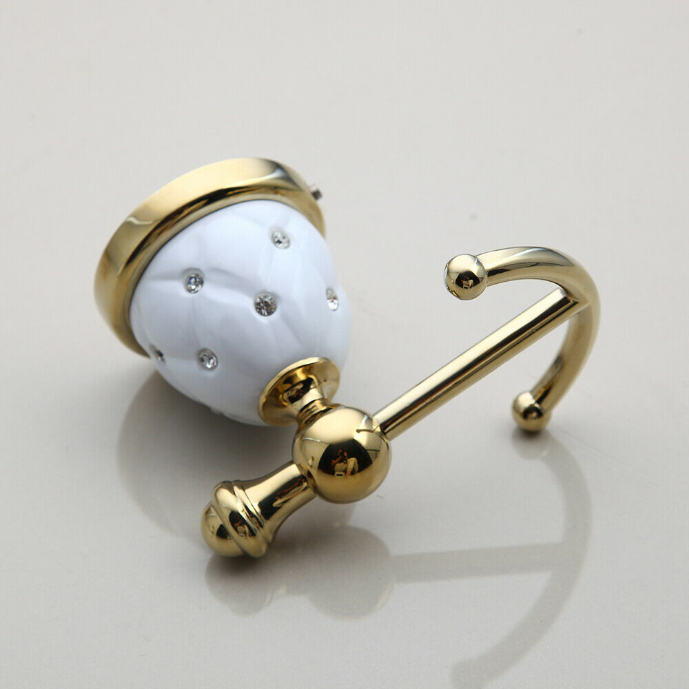 Goldfarbener Handtuchhaken mit weißen Elementen