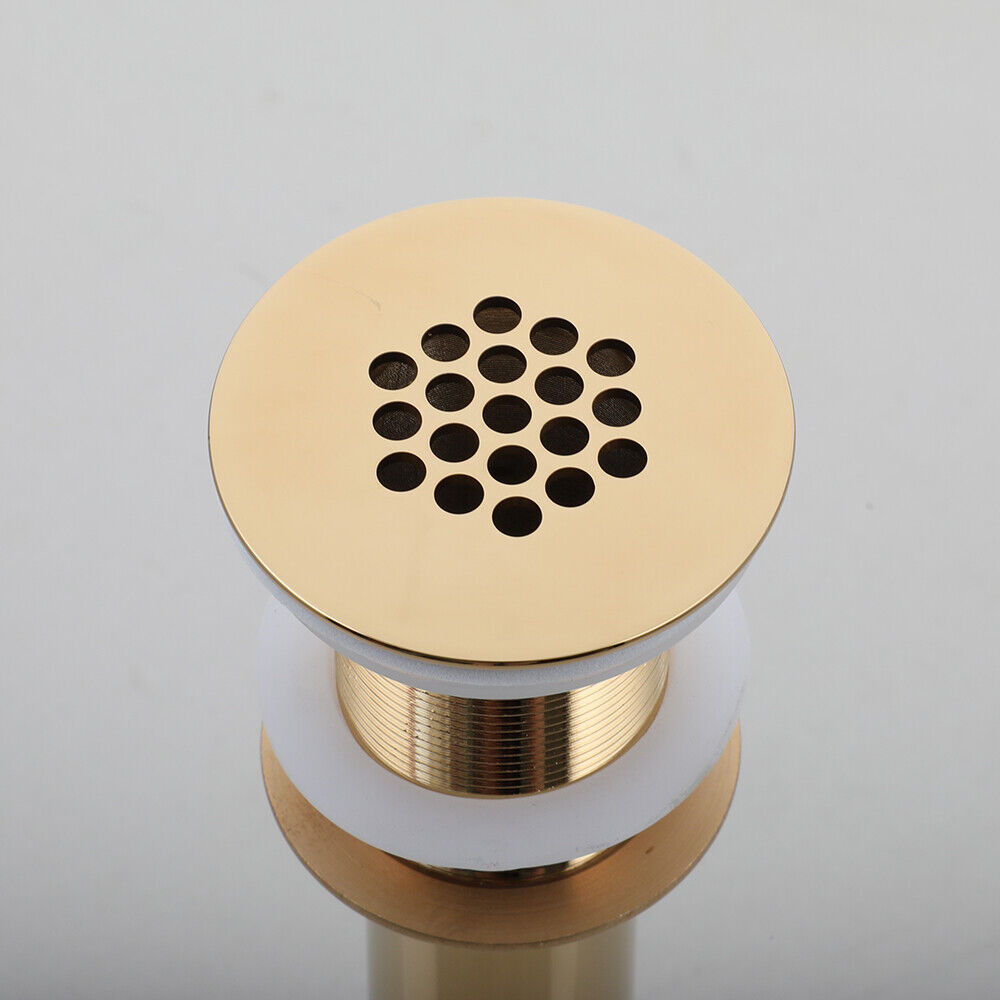 Gold-colored washbasin drain not closable