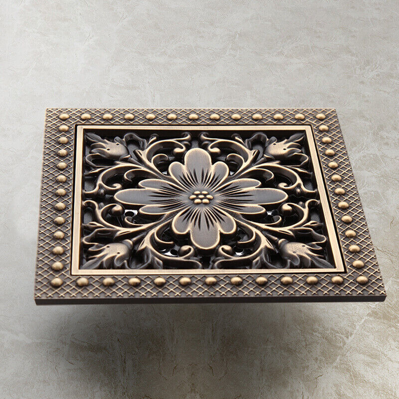 Bronze-colored shower drain with flower motif