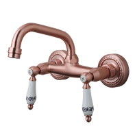 Koperkleurige landelijke muurkraan met keramische handgrepen