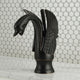 Elegant oil bronze washbasin tap in the shape of a graceful swan